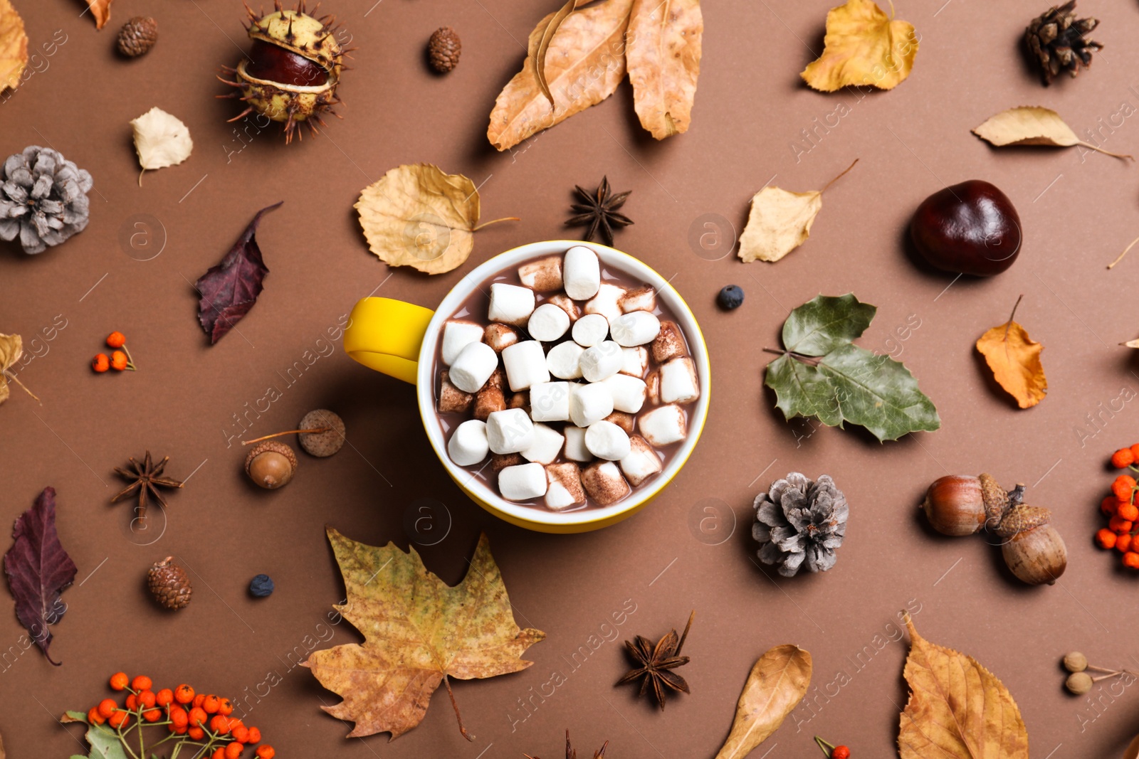 Photo of Flat lay composition with cup of hot drink on brown background. Cozy autumn atmosphere