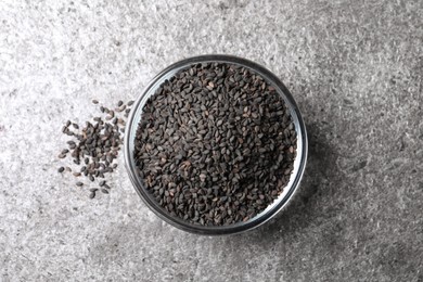 Photo of Black sesame seeds on grey table, flat lay