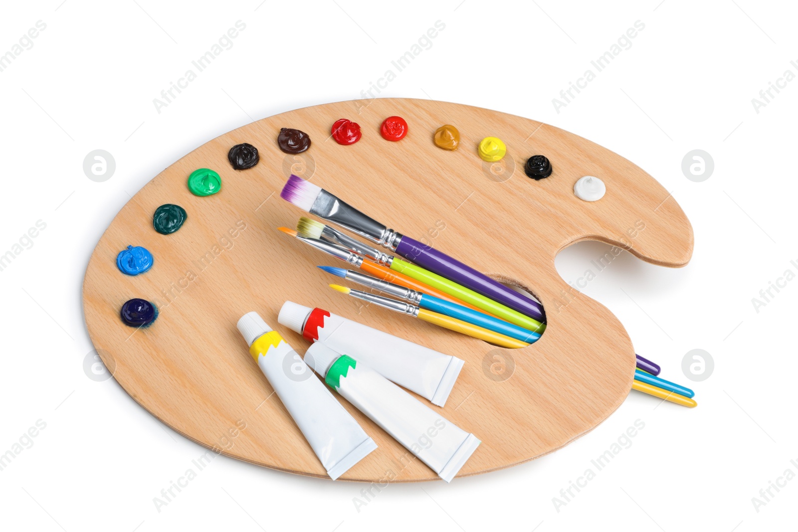 Photo of Palette with acrylic paints and brushes on white background. Artist equipment