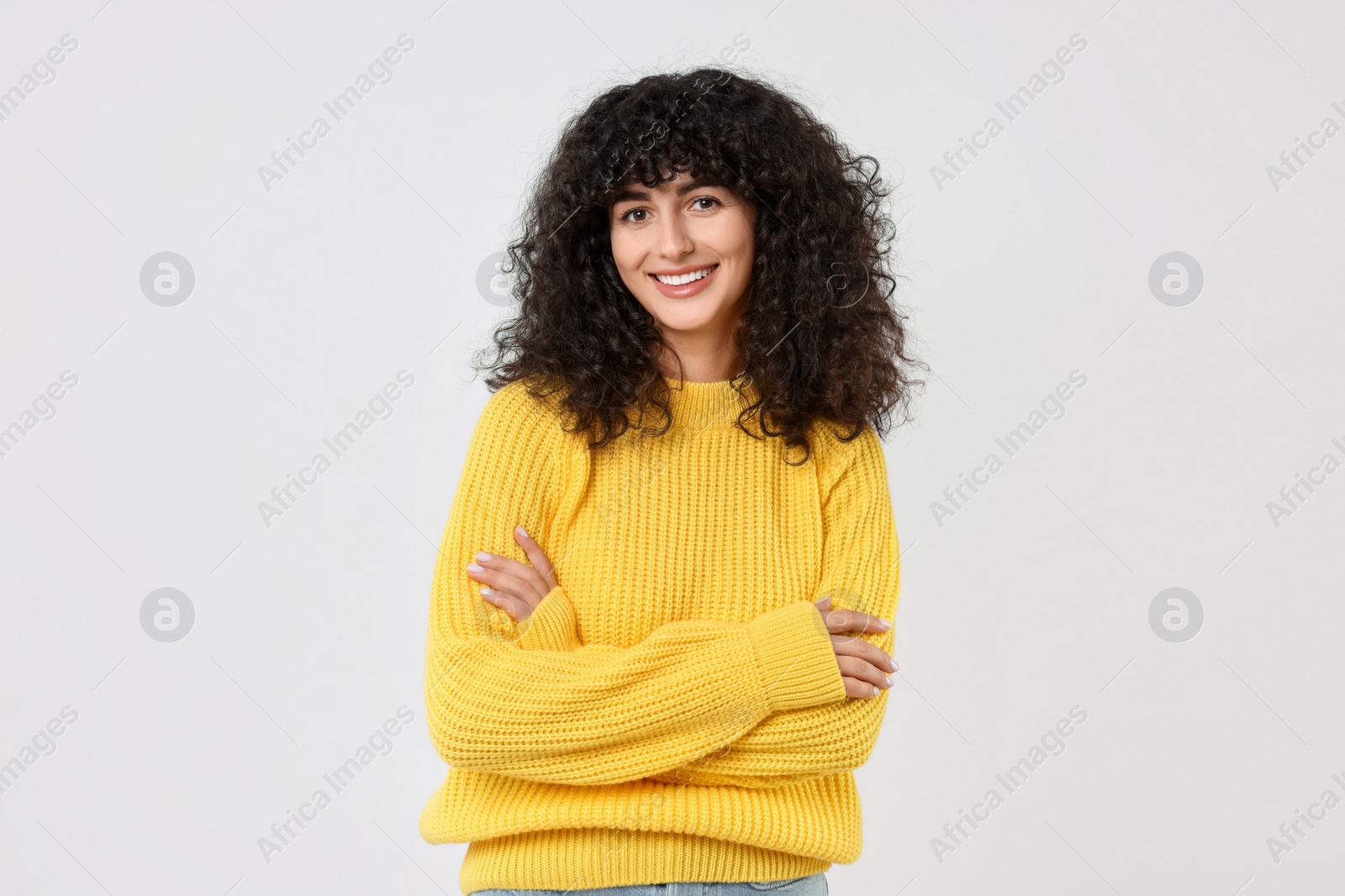 Photo of Happy young woman in stylish yellow sweater on white background