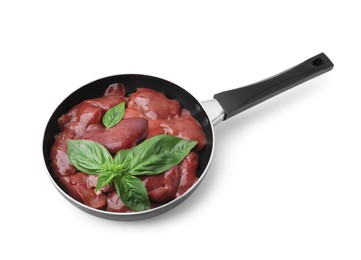 Photo of Raw chicken liver with basil in frying pan isolated on white