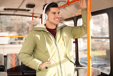 Man listening to audiobook in trolley bus