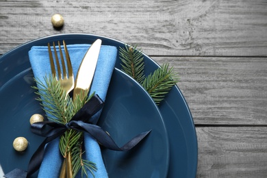 Photo of Christmas table setting on grey wooden background, flat lay