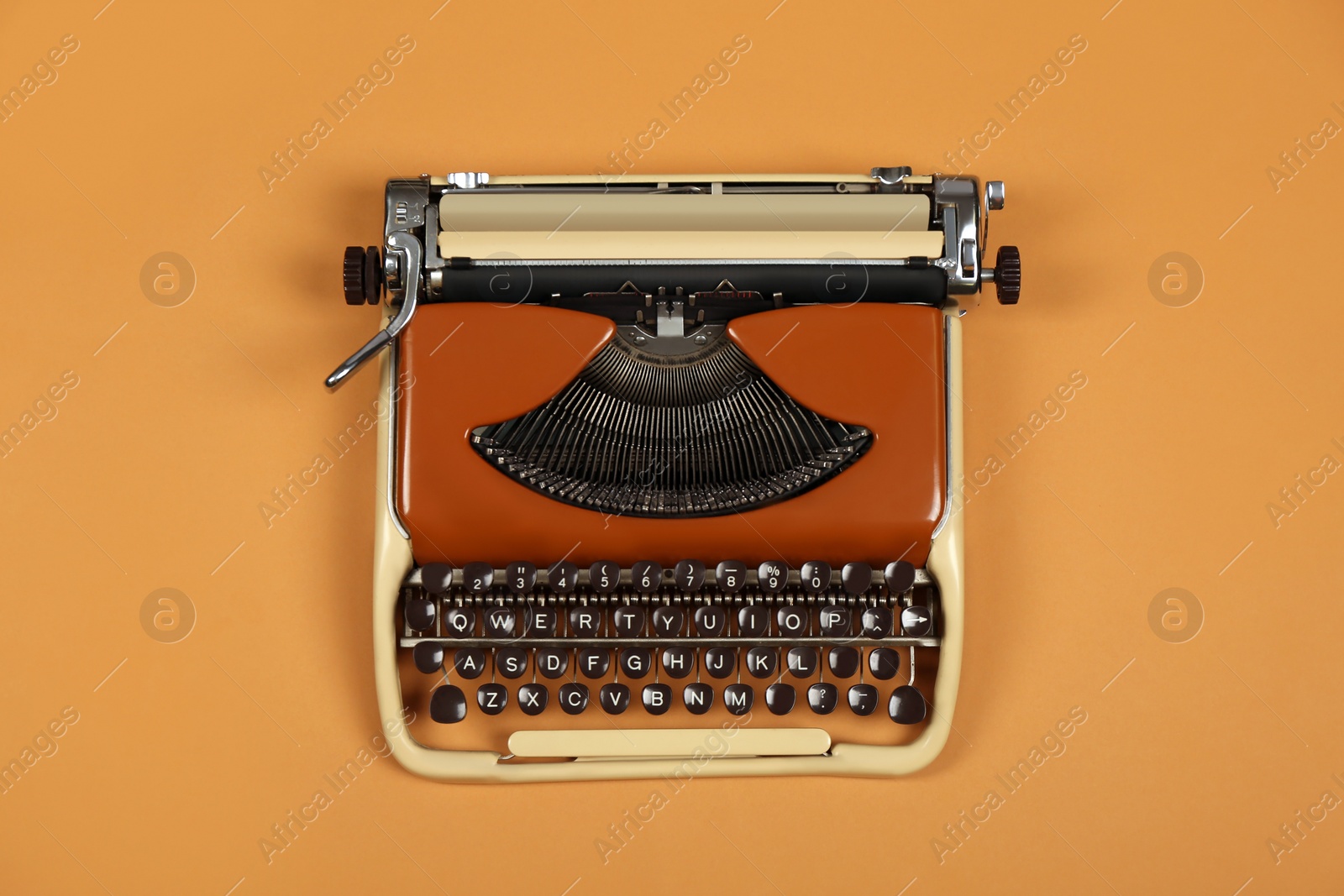 Photo of Vintage typewriter on brown background, top view