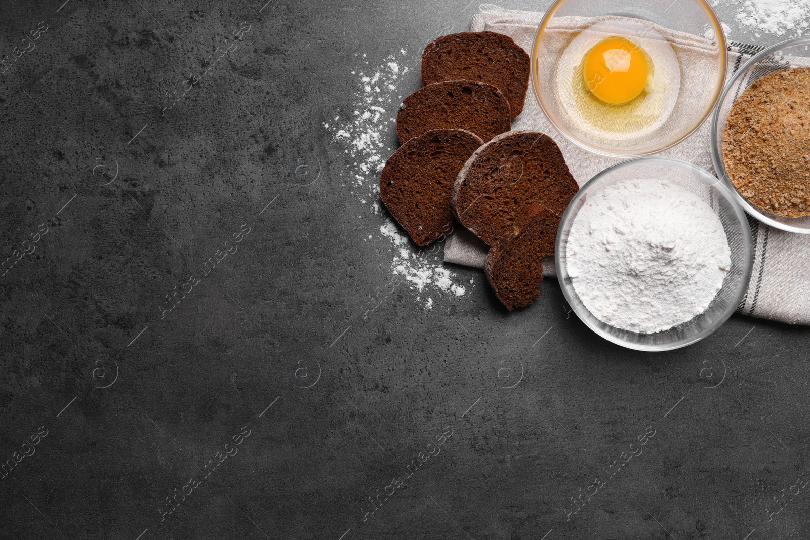 Photo of Fresh breadcrumbs, flour and egg on grey table, flat lay. Space for text