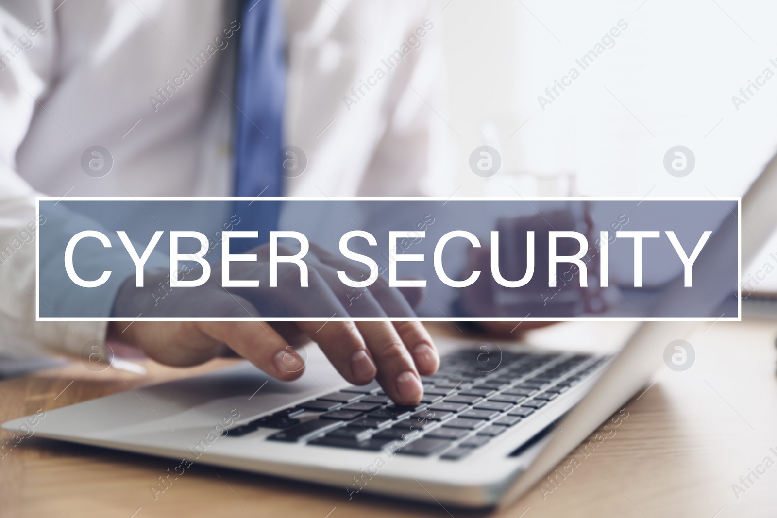 Image of Cyber security concept. Man working with laptop at table indoors, closeup