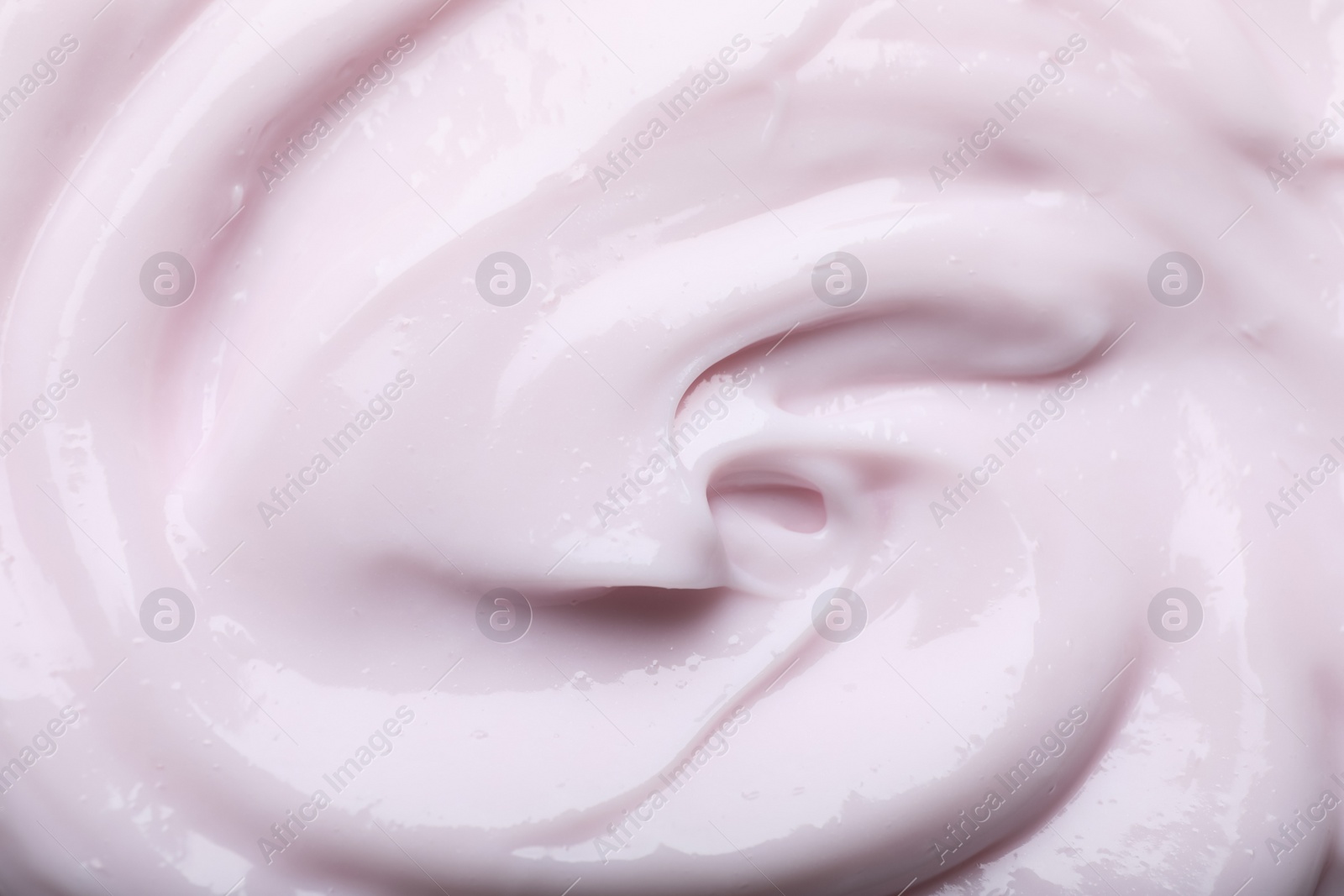 Photo of Closeup view of light pink body cream as background