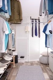 Modern dressing room with different stylish clothes and accessories