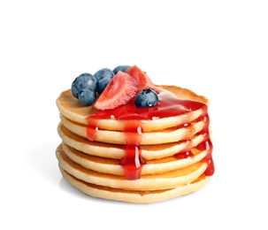 Photo of Stack of pancakes with berries and syrup on white background