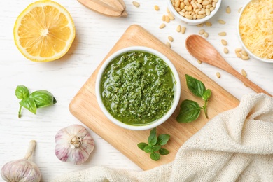 Photo of Flat lay composition with homemade basil pesto sauce and ingredients on table