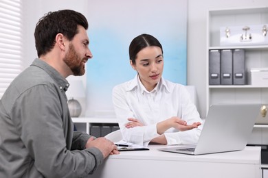 Doctor consulting patient during appointment in clinic