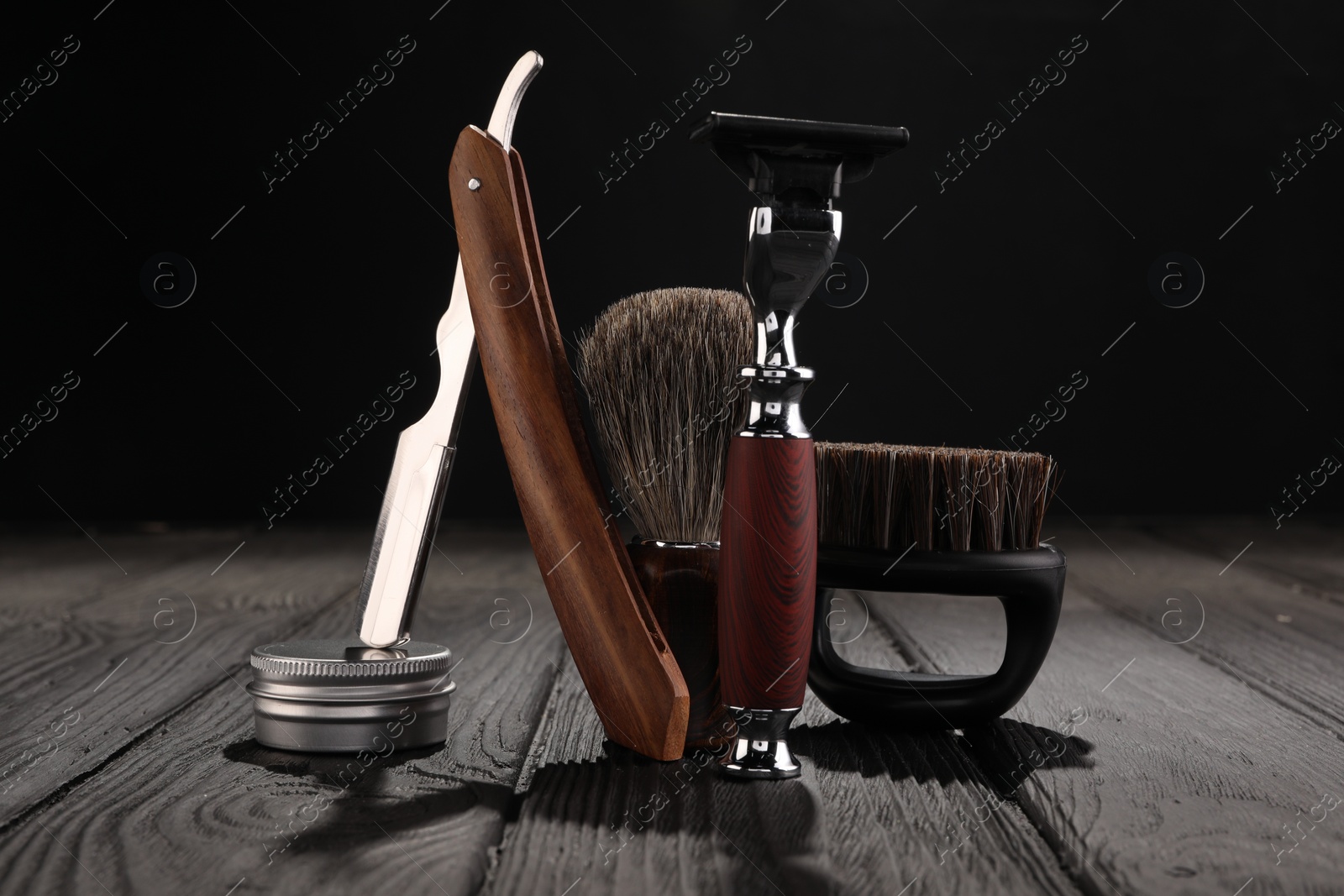 Photo of Moustache and beard styling tools on wooden table