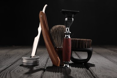 Photo of Moustache and beard styling tools on wooden table