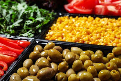 Salad bar with different fresh ingredients as background, closeup