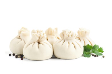 Photo of Uncooked khinkali (dumplings) and spices isolated on white. Georgian cuisine