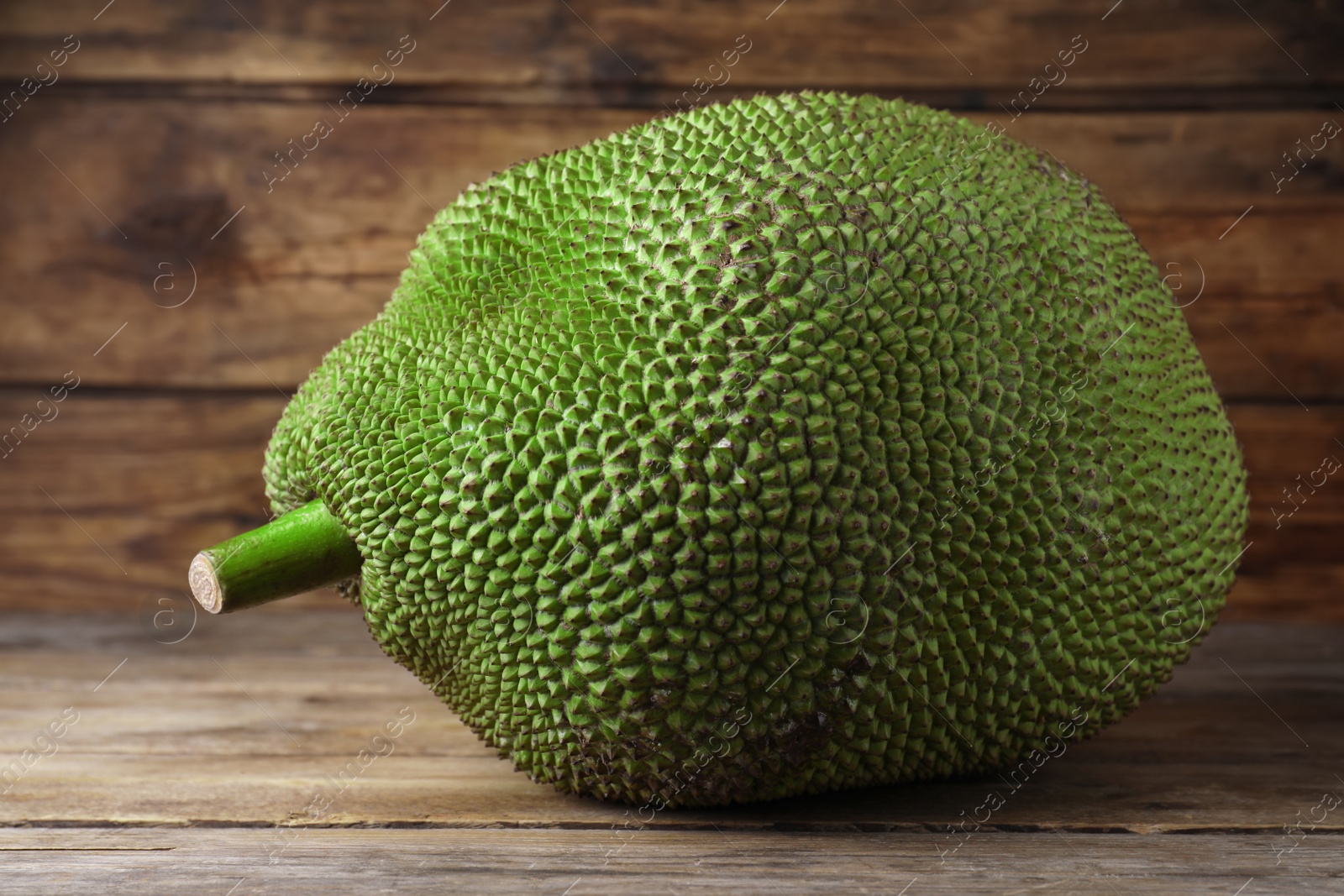 Photo of Fresh raw exotic jackfruit on wooden table