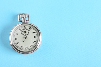 Vintage timer on light blue background, top view with space for text. Measuring tool