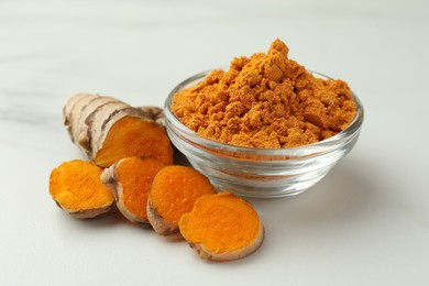 Photo of Aromatic turmeric powder and raw root on white table, closeup