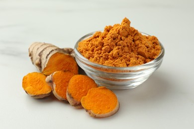 Aromatic turmeric powder and raw root on white table, closeup