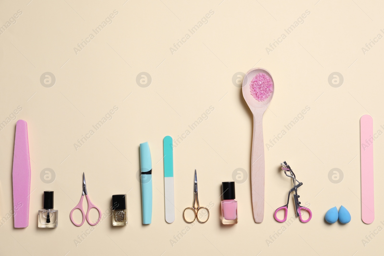 Photo of Flat lay composition with nail care products on beige background. Space for text