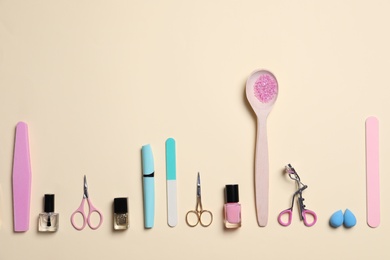 Photo of Flat lay composition with nail care products on beige background. Space for text