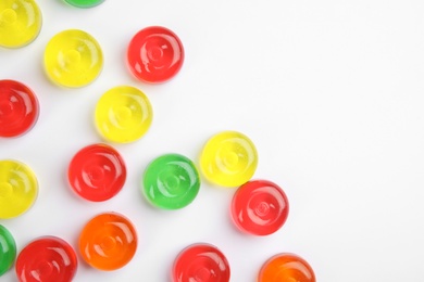 Photo of Delicious colorful candies on white background, top view