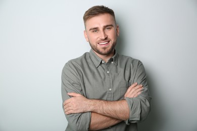 Photo of Handsome young man on light grey background