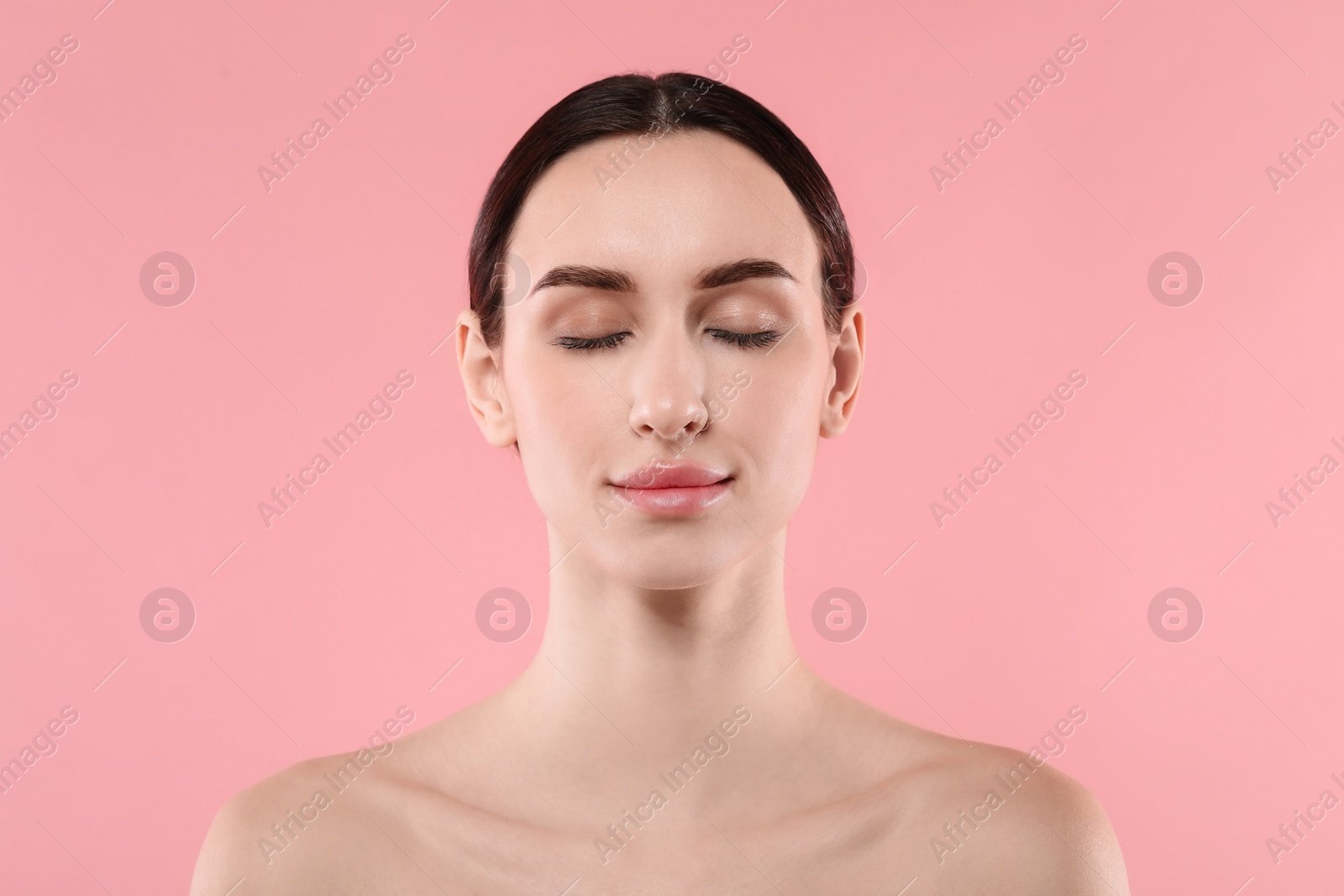 Photo of Portrait of beautiful young woman on pink background