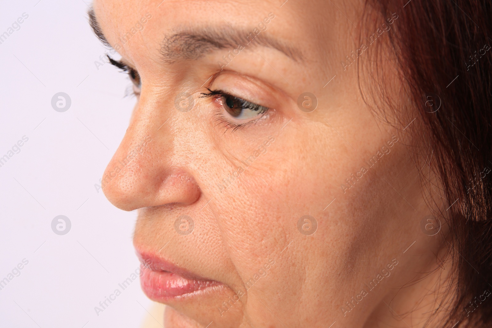 Photo of Closeup view of older woman on white background