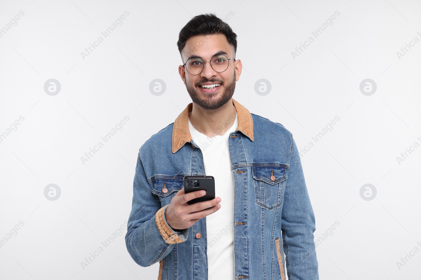 Photo of Happy young man using smartphone on white background