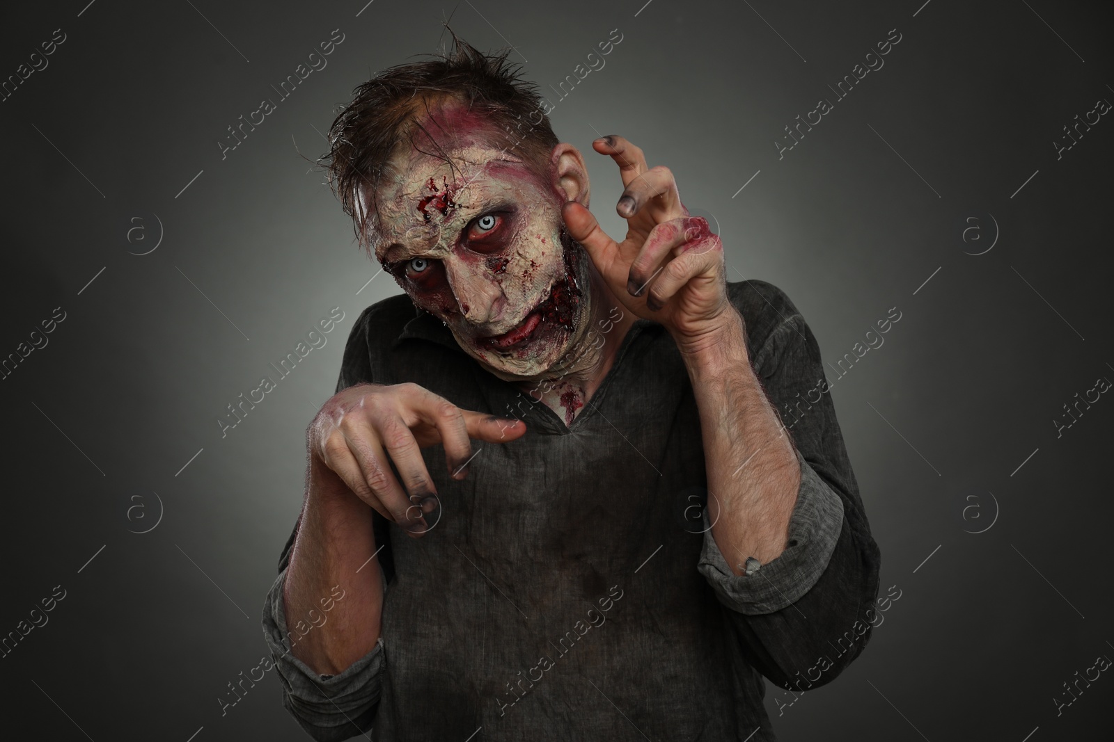 Photo of Scary zombie on dark background. Halloween monster