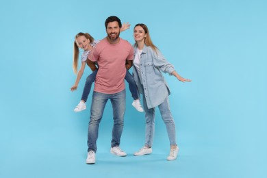 Photo of Happy family together on light blue background