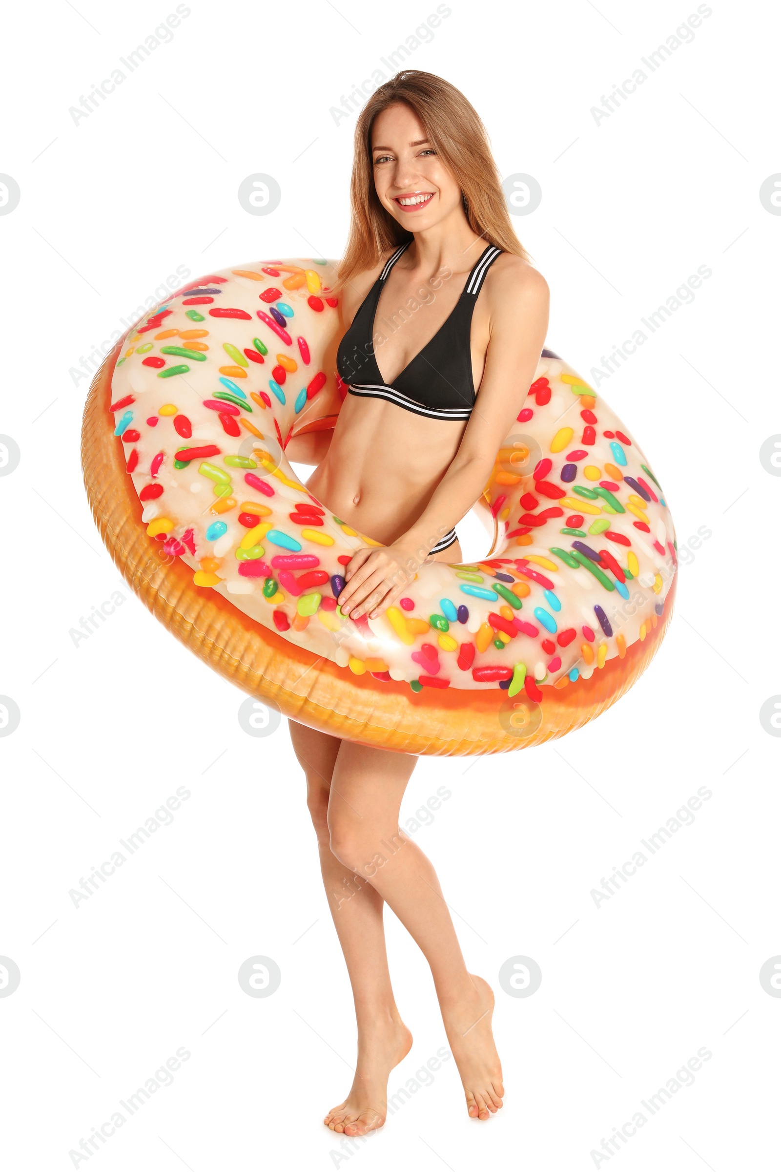 Photo of Beautiful young woman in stylish bikini with doughnut inflatable ring on white background