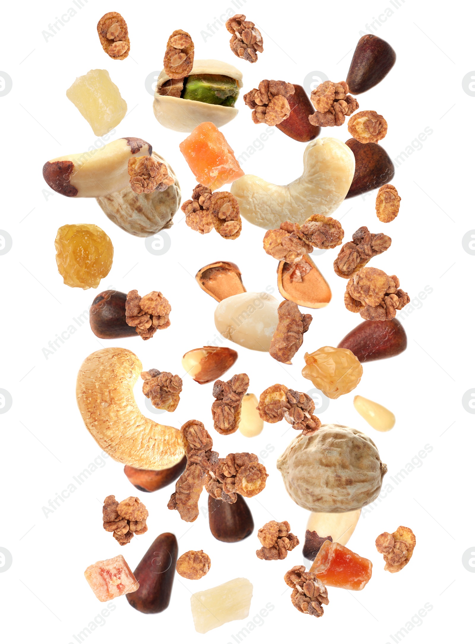 Image of Delicious granola, nuts and dried fruits falling on white background. Healthy snack 