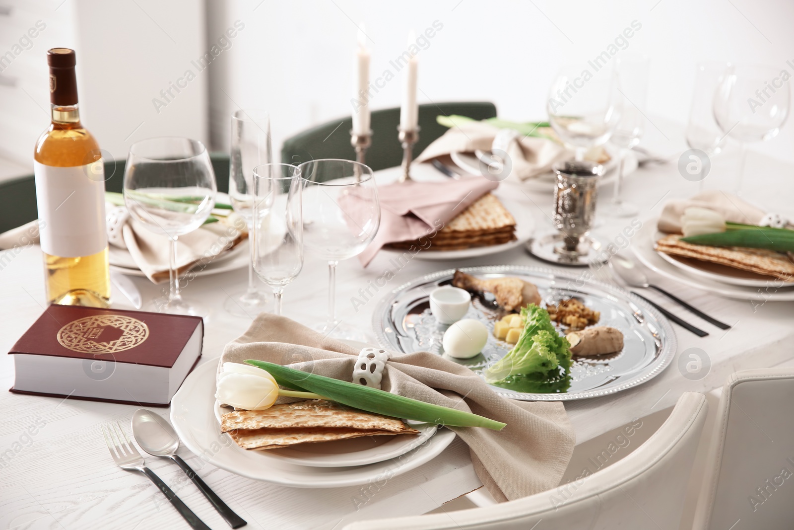 Photo of Festive Passover table setting with Torah. Pesach celebration