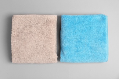 Photo of Soft bath towels on grey background, top view