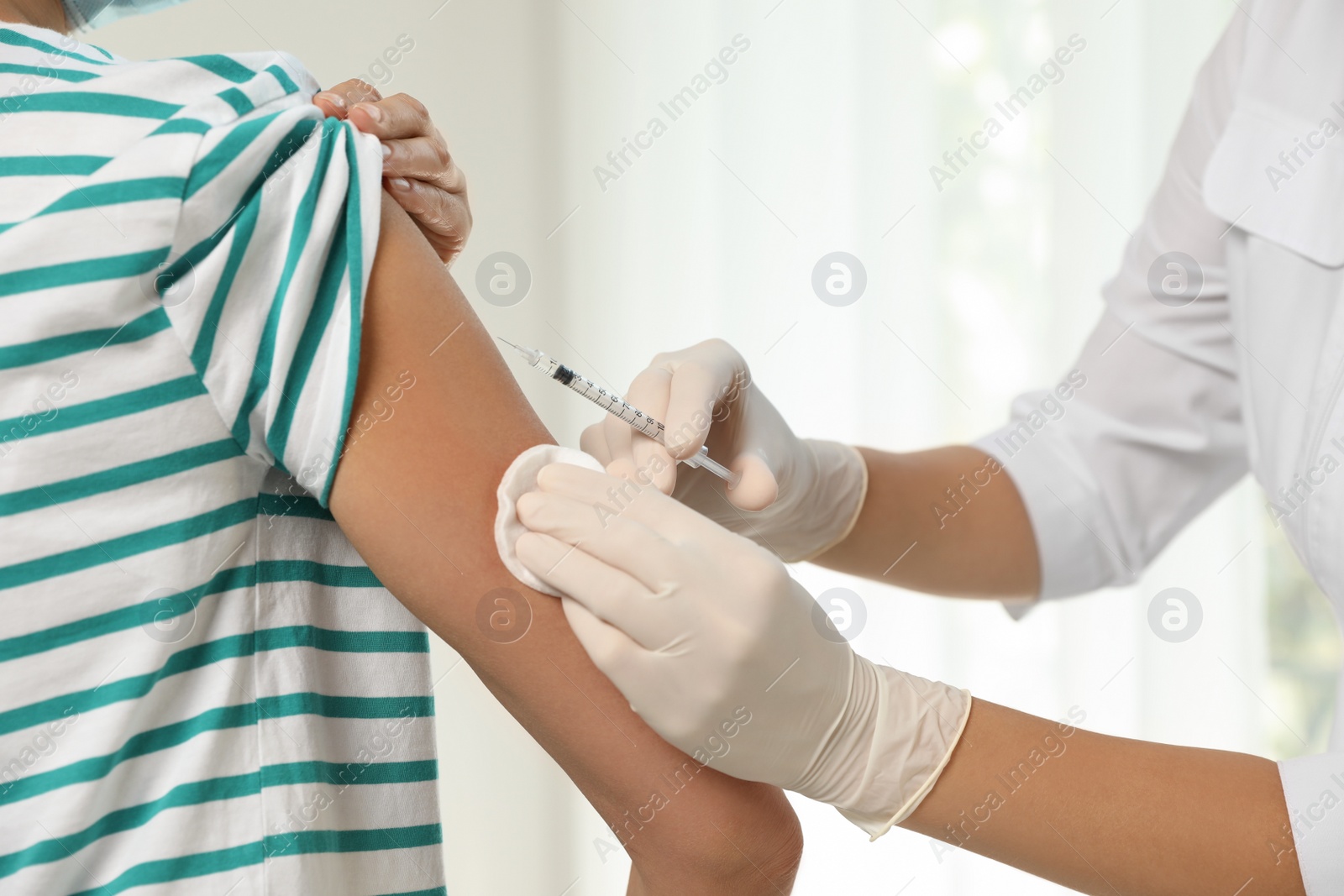 Photo of Doctor giving injection to patient in hospital, closeup. Vaccination day