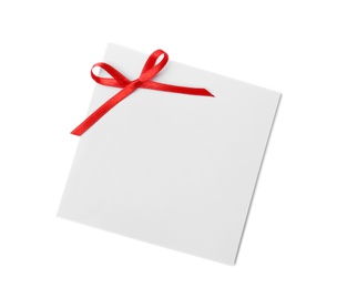 Photo of Blank gift tag with satin ribbon on white background, top view