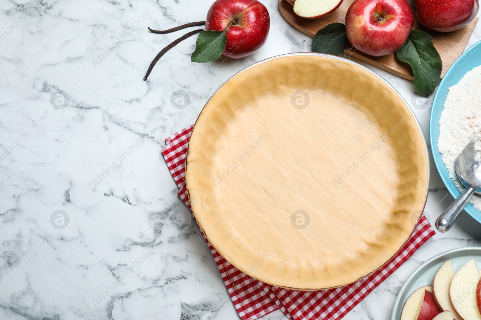 Photo of Flat lay composition with raw dough and ingredients on white marble table, space for text. Baking apple pie