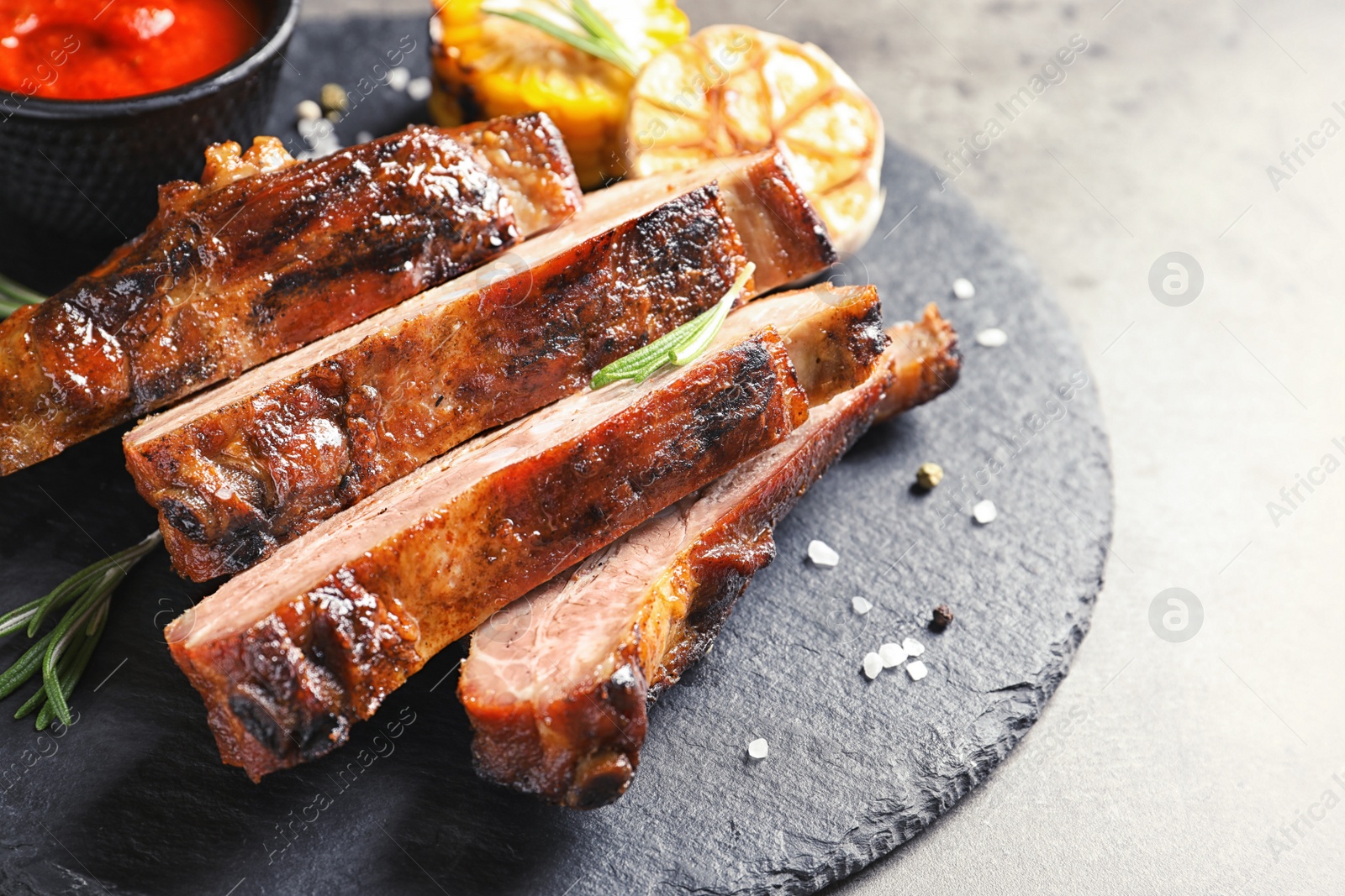 Photo of Delicious meat served for barbecue party on gray table