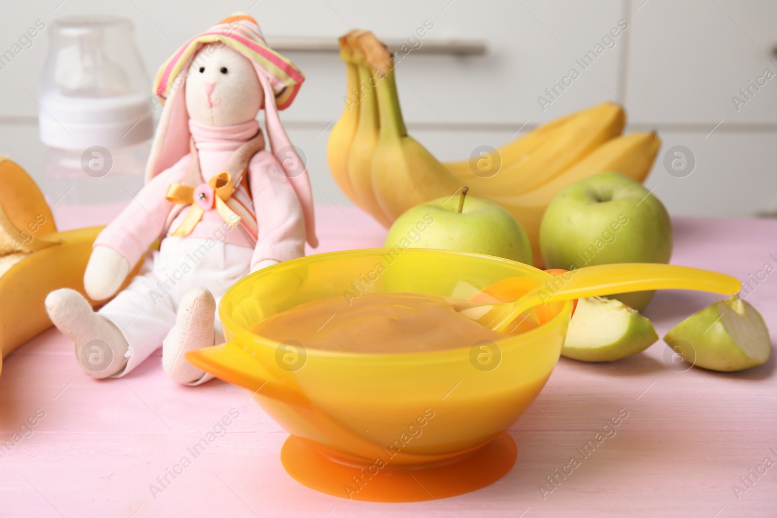 Photo of Bowl of healthy baby food on wooden table