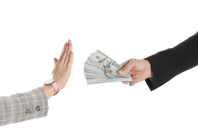 Photo of Woman refusing to take bribe on white background, closeup of hands