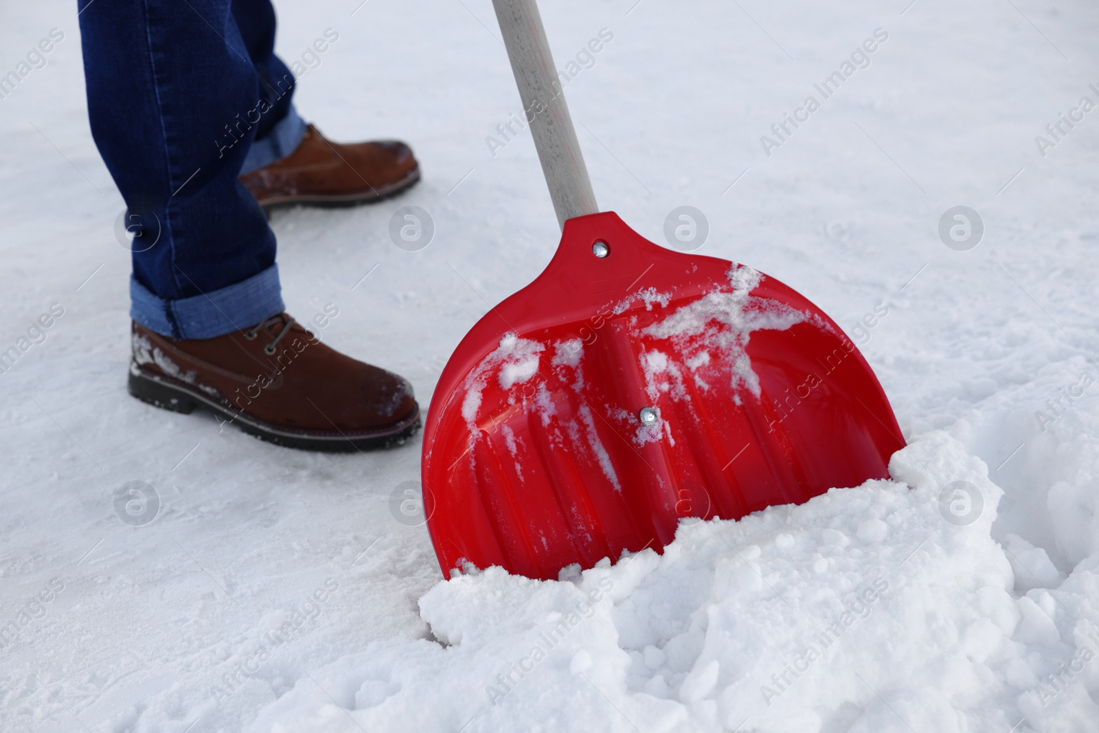 Photo of Man removing snow with shovel outdoors, closeup