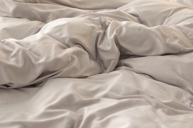 Photo of Bed with stylish silky linens, closeup view