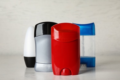 Photo of Set of different male deodorants on light grey table