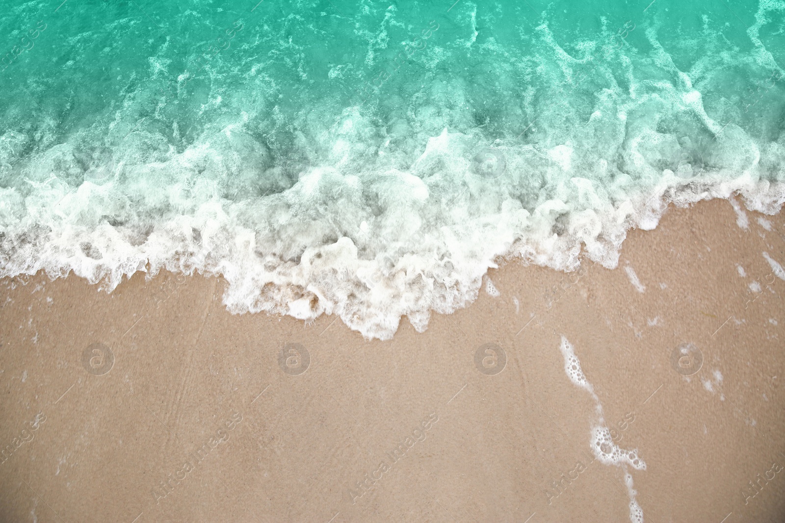 Photo of Beautiful view of sea tide on sandy beach. Summer vacation