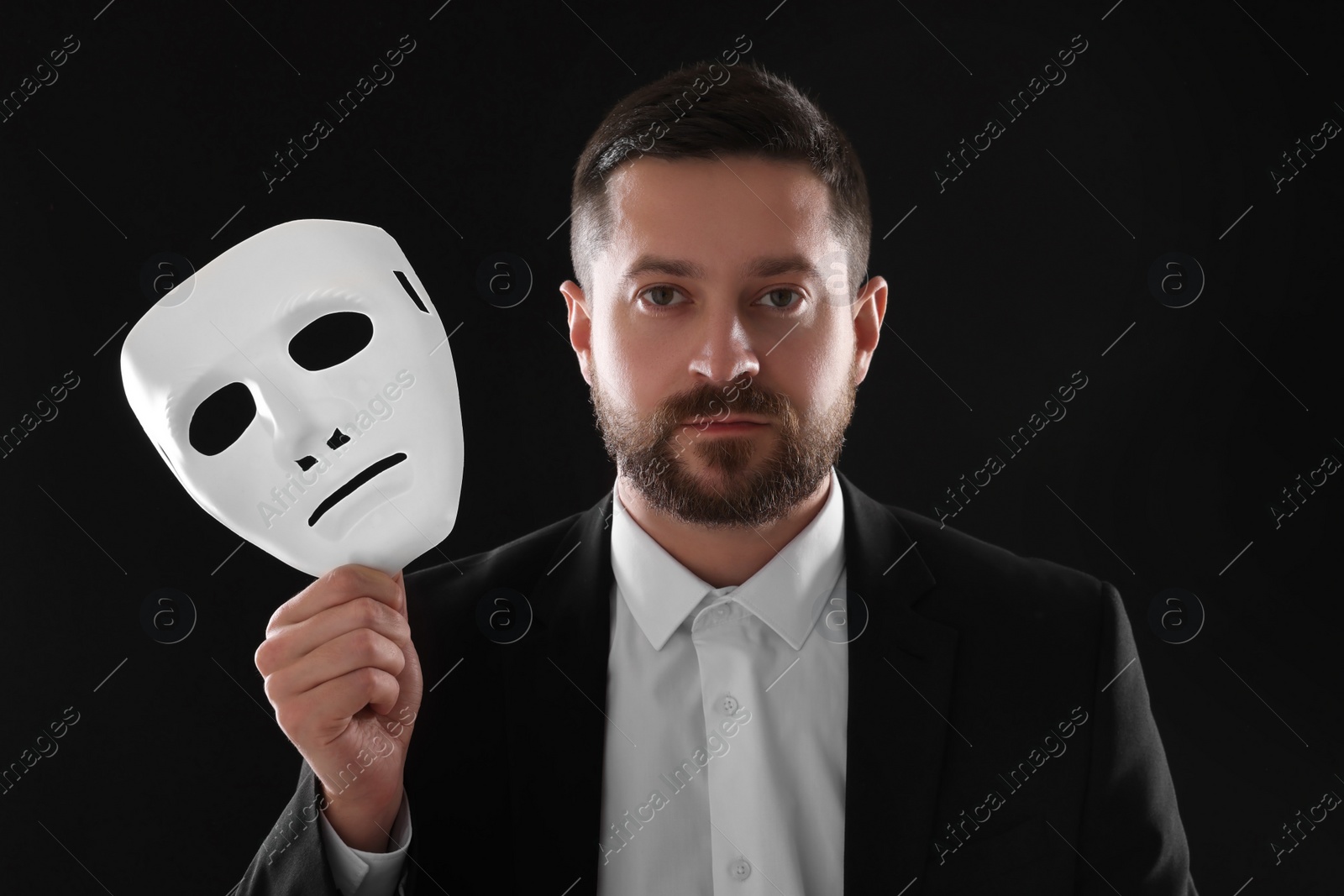 Photo of Multiple personality concept. Man with mask on black background