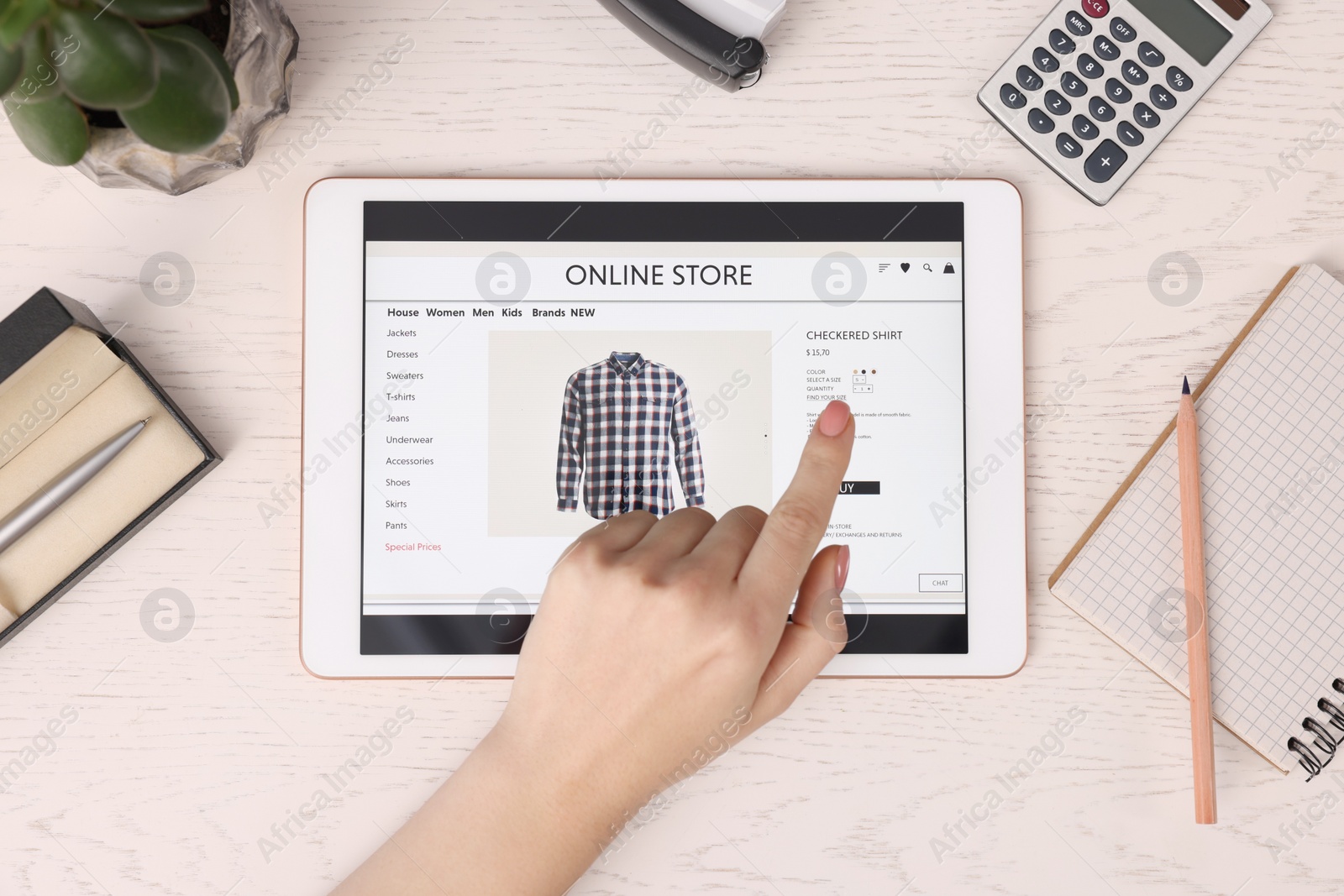 Photo of Woman with tablet shopping online at white wooden table, top view