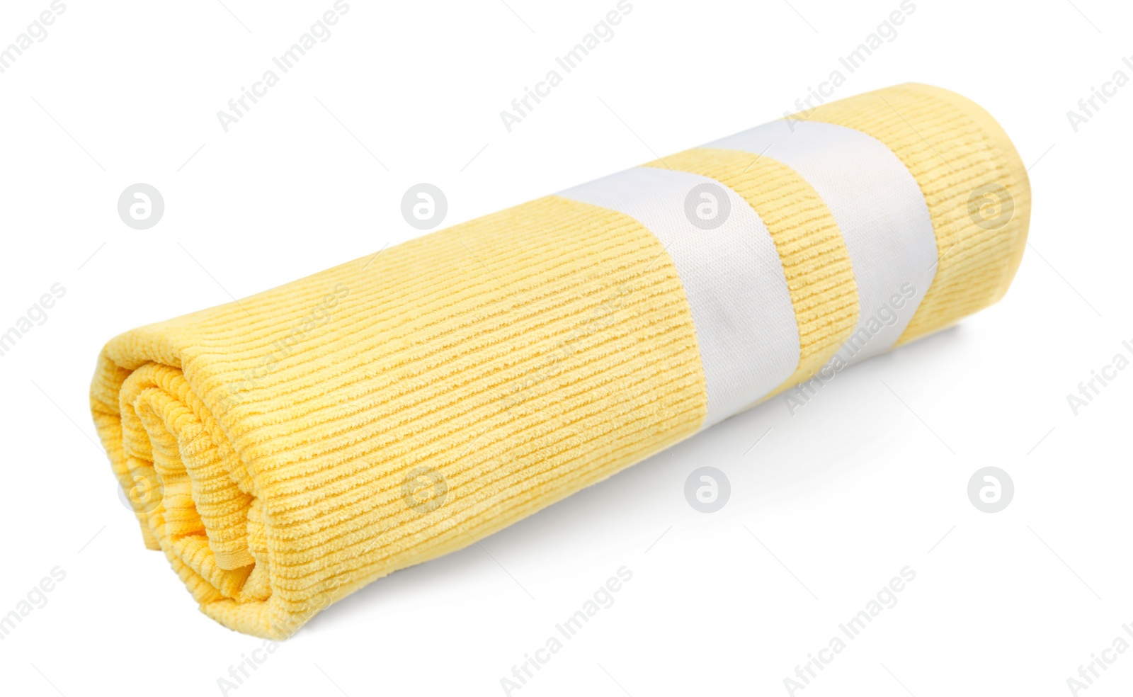 Photo of Rolled yellow beach towel on light grey background