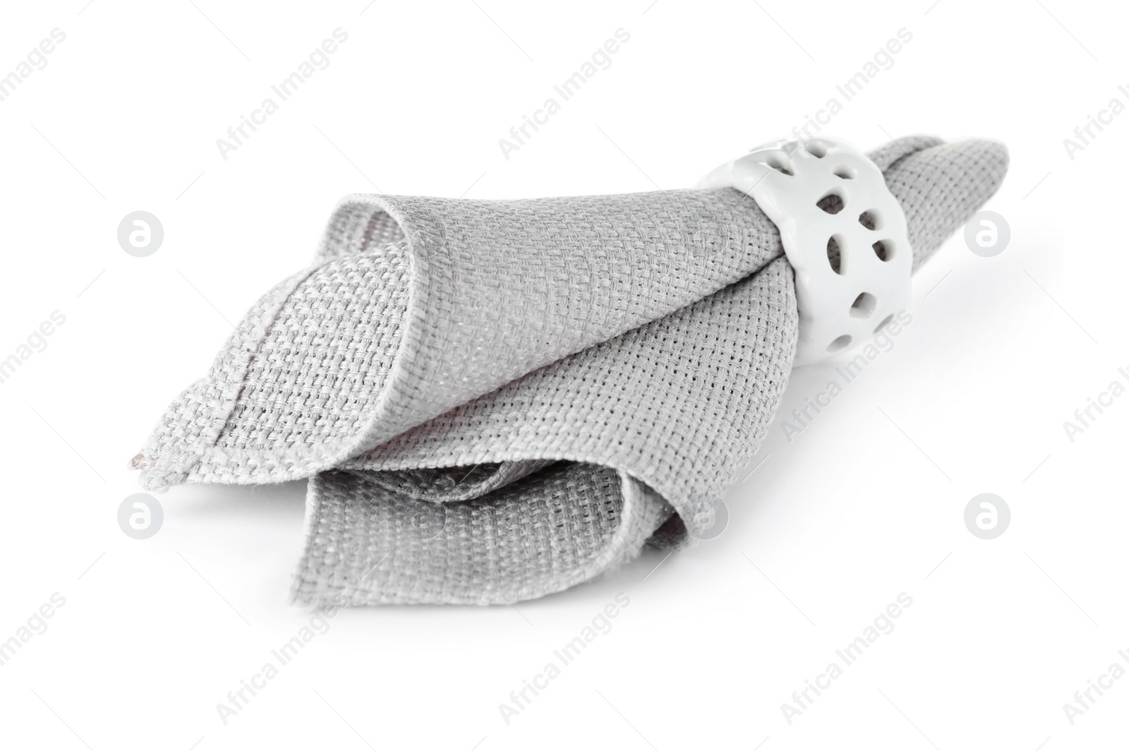 Photo of Fabric napkin with decorative ring for table setting on white background